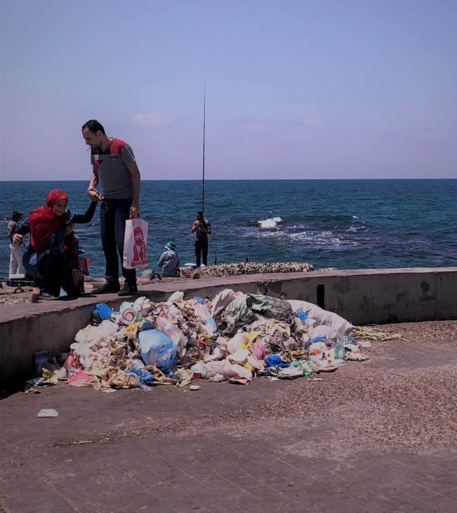 Tarnished view of the Mediterranean Sea at Alexandria. There is a huge pile of garbage at the base of the picture.