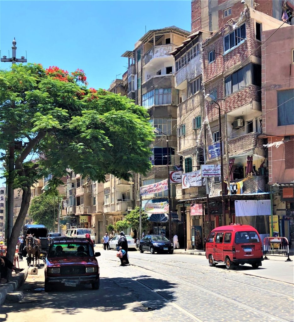 The streets of Alexandria, Egypt are quieter than Cairo. Small vehicles, people and horse and carriages are on the streets.