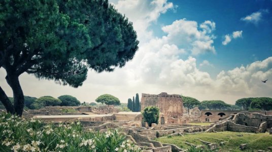 The picturesque ruins of Ostia Antica, near Rome, hills, trees and flowers