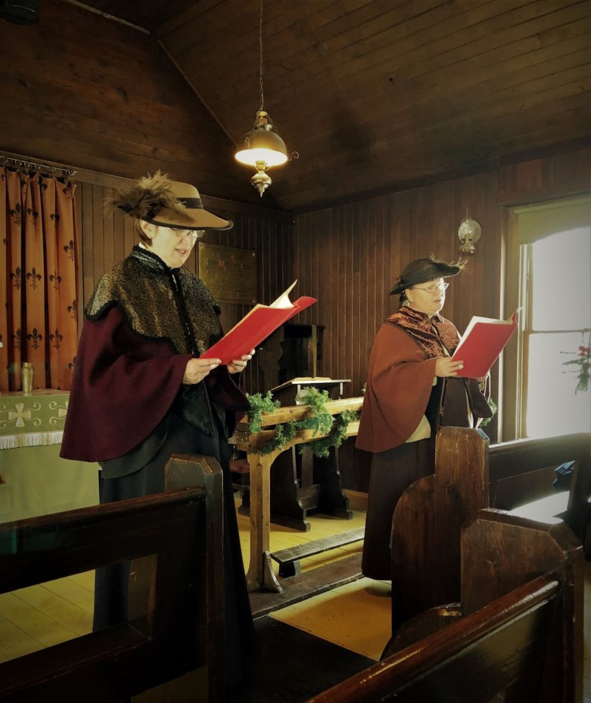 Leading the congregation in a round of Christmas carols inside the chapel at Heritage Park for Once Upon a Christmas