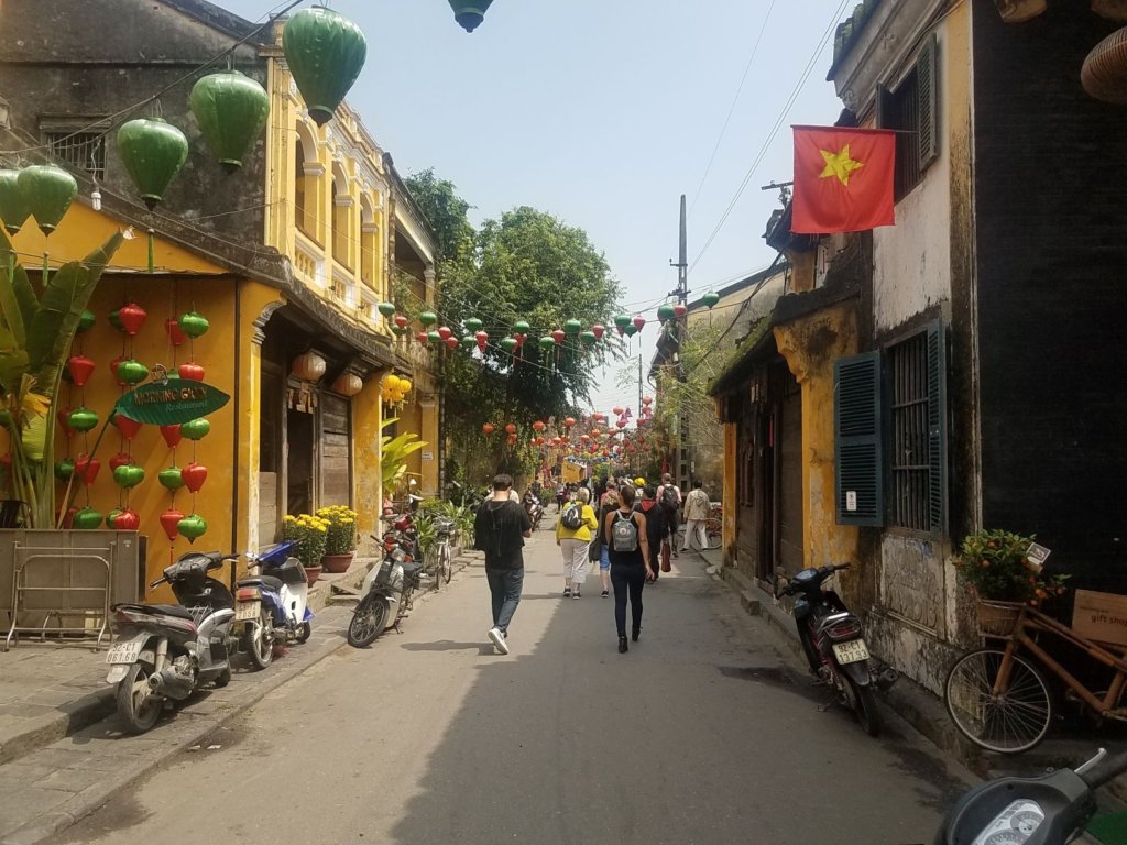 Old town Vietnam with motorbikes and people walking on the street