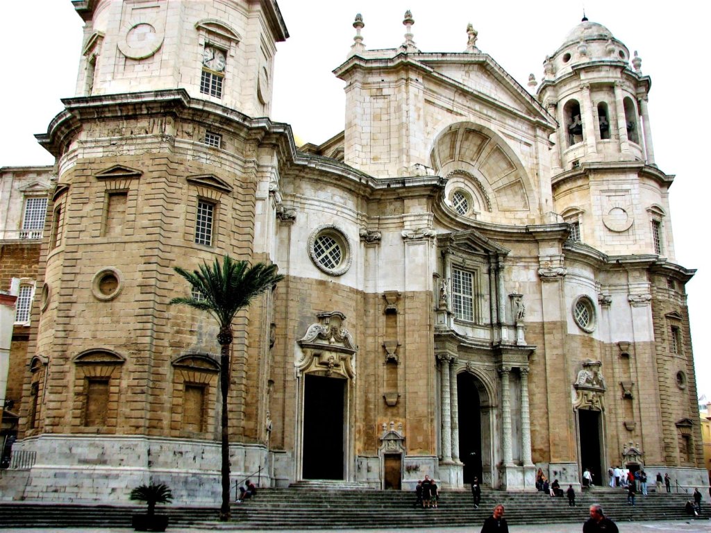 The Cadiz Cathedral with enormous wooden doors and bell towers
