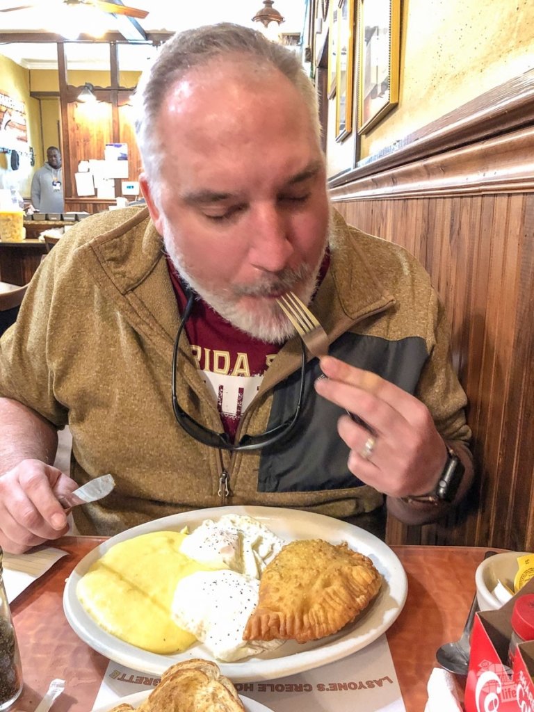 Man eating brunch of eggs and meat pies