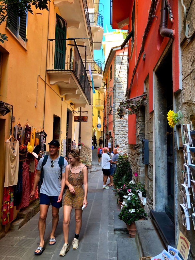 The narrow streets of Corniglia Cinque Terre with colourful houses and tourists