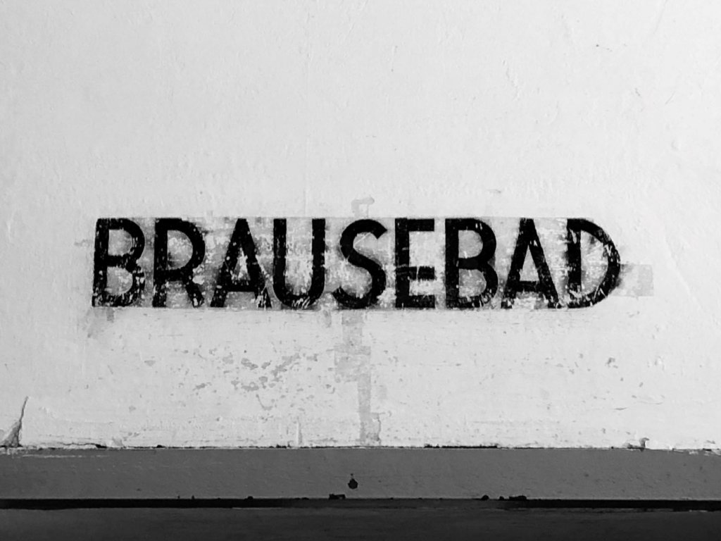 The word Brausebad is located above the showers inside the crematorium at Dachau Concentration Camp.