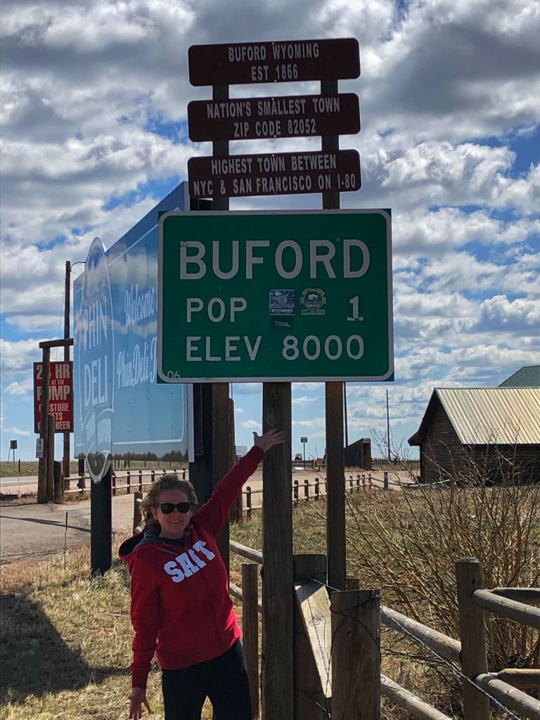 Lady standing underneath Buford Wyoming sign