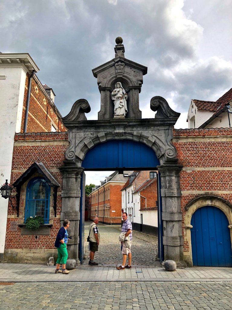 The entrance to the béguinage in Lier, Belgium is marked by a monumental blue stone gate, dated to 1690. On top of the gate is a terracotta statue of Saint Begga dated 1777, the patron saint of the béguines.