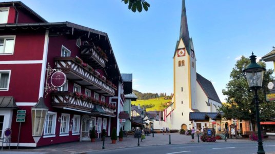 the streets of Abtenau, Austria with buildings and a church.