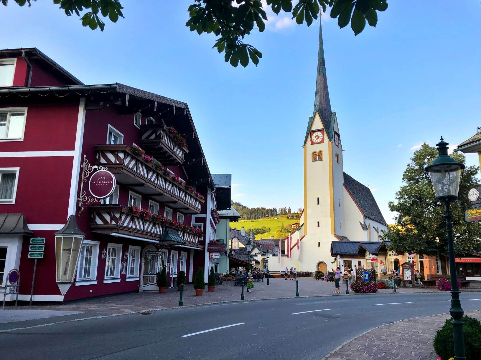 the streets of Abtenau, Austria with buildings and a church.