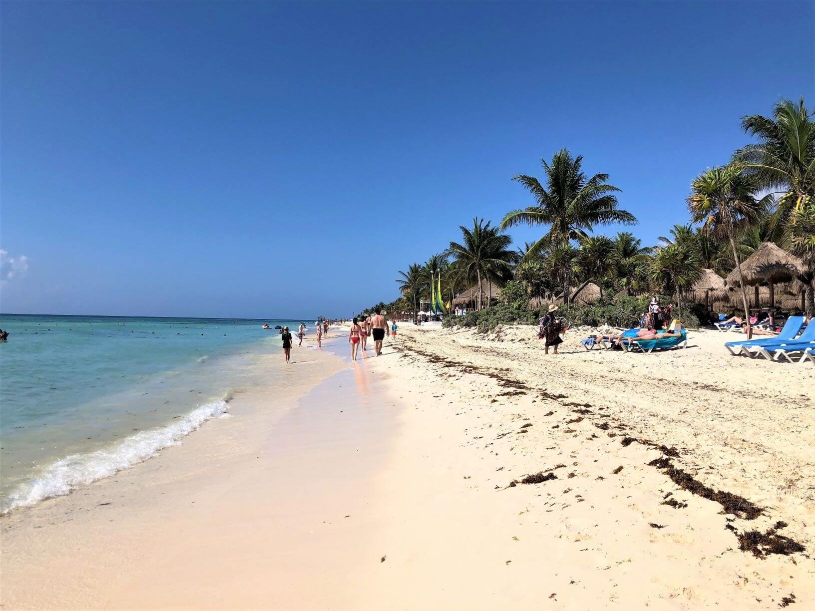beach in Mexico with sand, surf, and people in swimming suits.