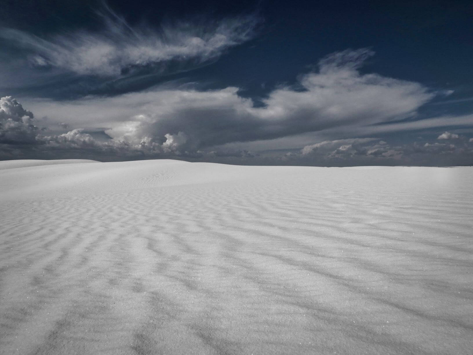 White sand dunes and sky with clouds