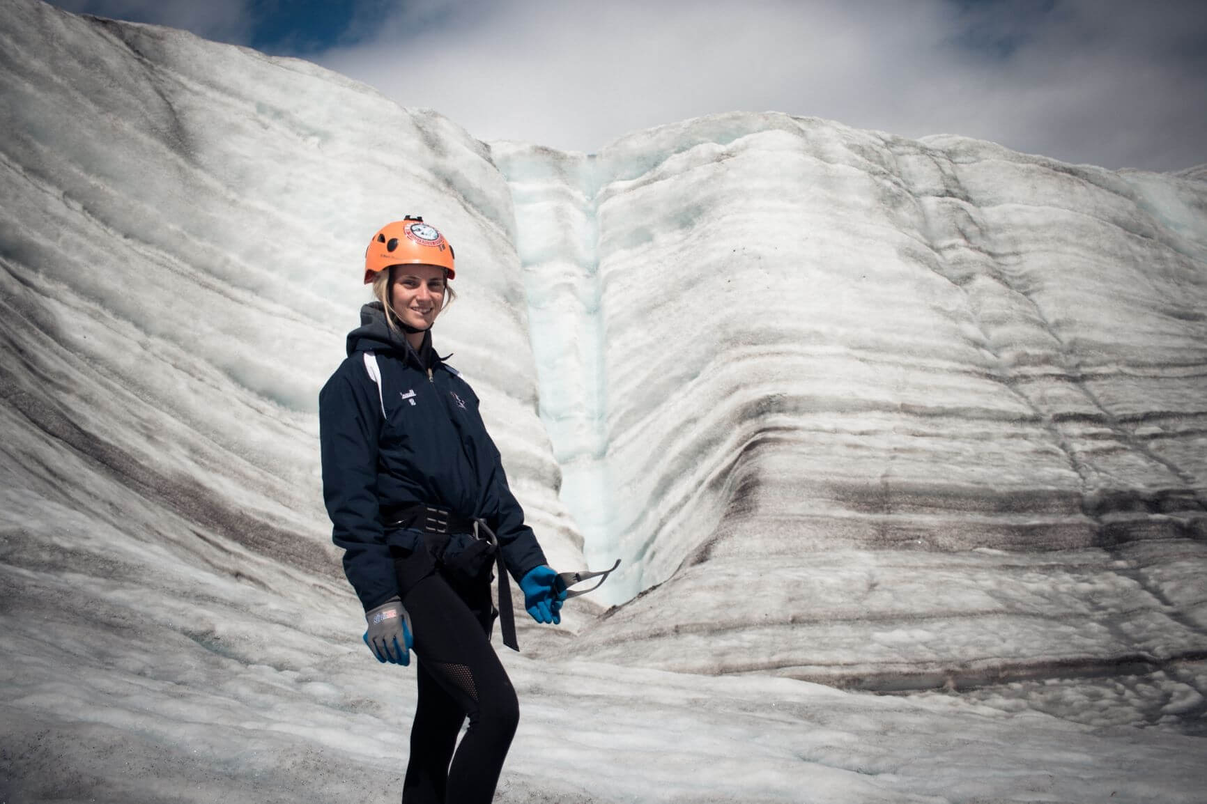 Lady standing in front of a glacier in Alaska.