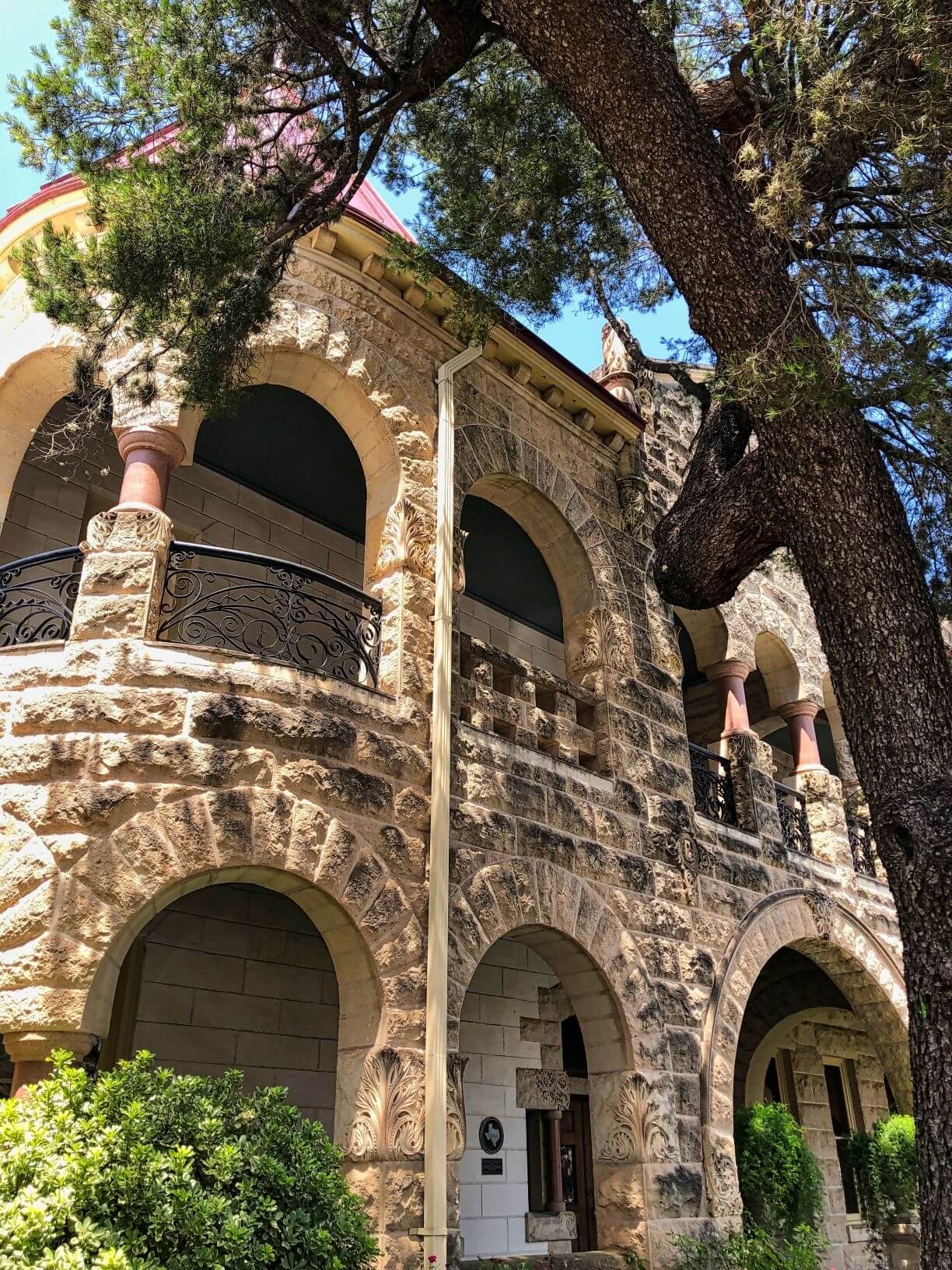 Limestone two story building with arches