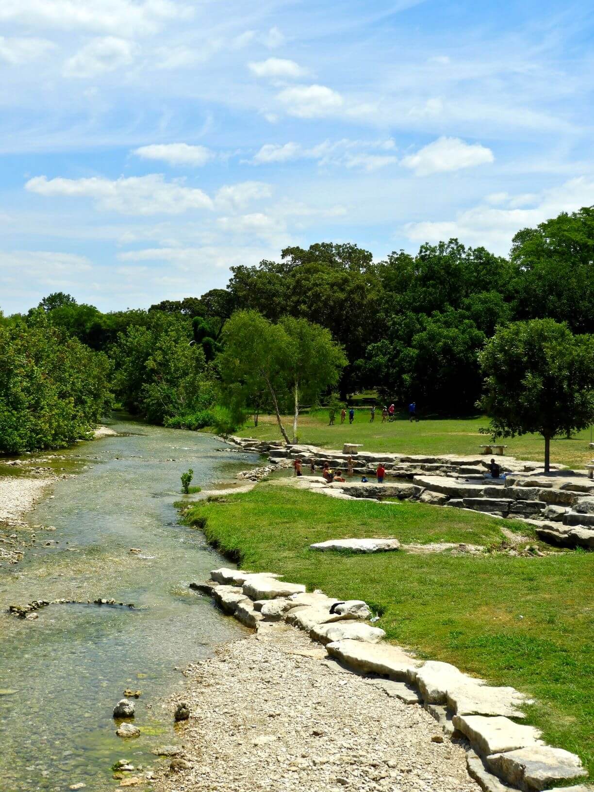 Salado Creek east view with people swimming in it.