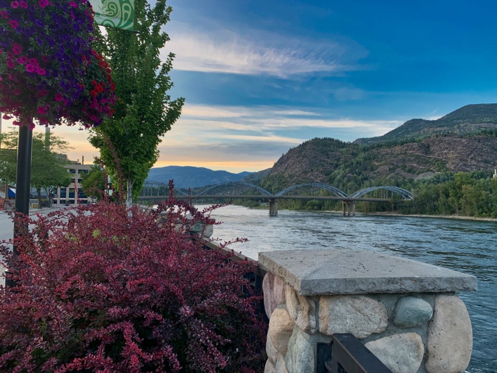 The Columbia River in Trail British Columbia at sunset with flowers