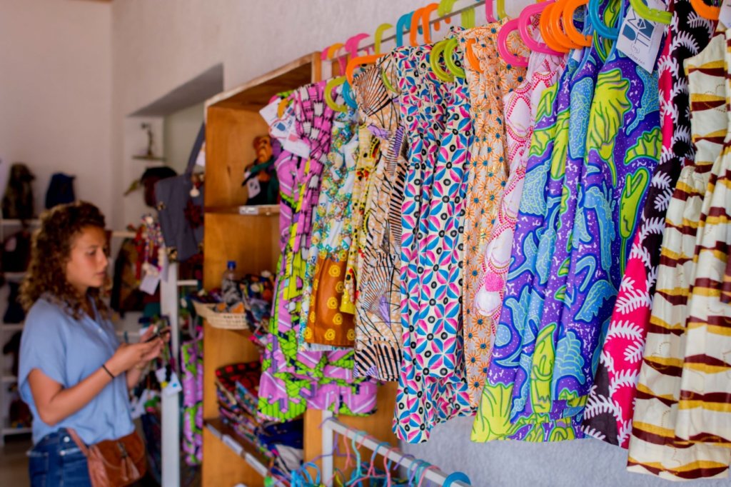 woman shopping in a store with colourful fabric.