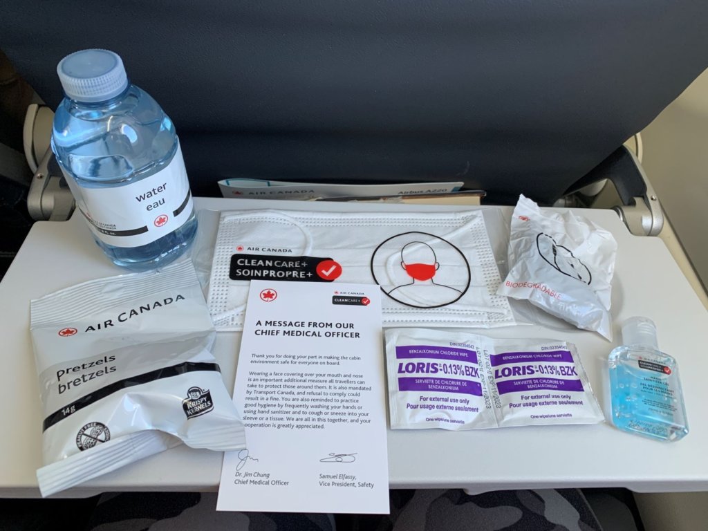 personal protective equipment provided by Air Canada on flights, mask, hand sanitizer, water, wipes, pretzels, headphones