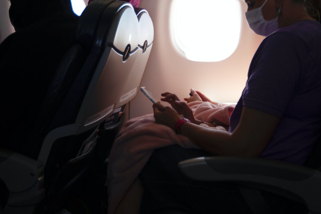 people on an airplane wearing masks